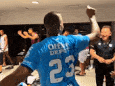 a man in a blue jersey with the number 23 on the back