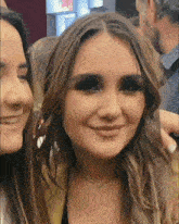 two women are posing for a picture together and one of them is smiling