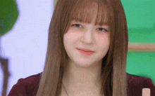 a close up of a young woman with long hair and bangs looking at the camera .