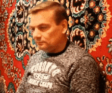 a man wearing a grey sweater that says ' york ' on it