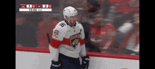 a hockey player wearing a number 16 jersey stands on the ice