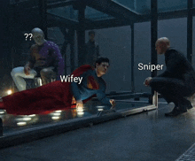 a man in a suit is laying on a glass floor next to a sniper