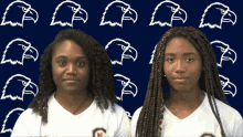 two girls are standing in front of a blue background with white eagles