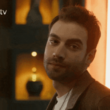 a close up of a man 's face with the word tv visible in the corner