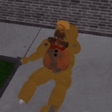 a teddy bear is laying on the sidewalk with a brick wall in the background .