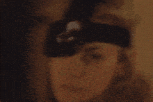 a close up of a woman wearing a beanie and smiling .