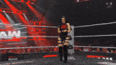 a woman in a wrestling ring with a w logo