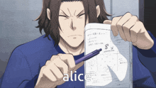 a man in a blue shirt is holding a piece of paper with the word alice on it