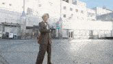a man in a suit is holding a blue object in front of a white building