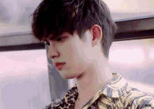 a close up of a young man 's face with the word dia on the bottom