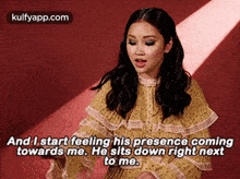 a woman in a yellow dress is saying `` and i start feeling his presence coming towards me .