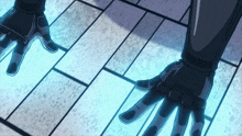 a person wearing a pair of black gloves is standing on a tile floor