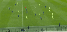 a group of soccer players are playing on a field .