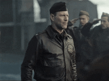 a man in a military uniform salutes while wearing a hat that says ' a ' on it