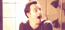 a man is making a surprised face with his mouth open and his eyes closed .