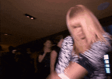 a blurry picture of a woman dancing in a club