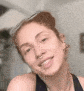 a close up of a woman with a nose ring and earrings .