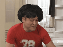 a man wearing a red shirt that says 78 on it