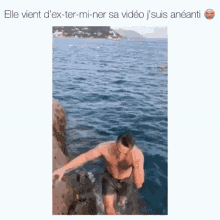 a shirtless man is standing on a rock in the ocean with the caption elle vient d' ex-ter-mi-ner sa video