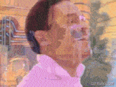 a gif from gifrun.com shows a man 's face in a pink shirt