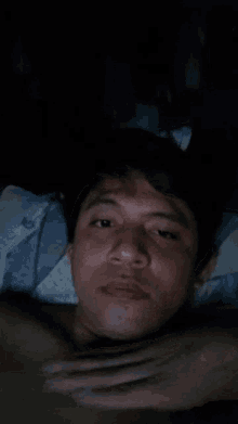 a blurry picture of a person 's face with a blue blanket in the background
