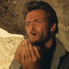 a man with a beard is smoking a cigarette with his mouth open