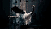 a man in a white dress is floating in the water
