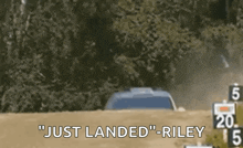 a car is driving down a dirt road and the words `` just landed '' are being displayed .