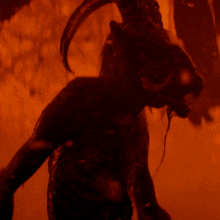 a silhouette of a goat with horns standing in a dark room