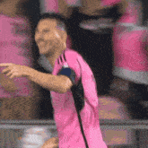 a soccer player in a pink jersey with the word adidas on the front