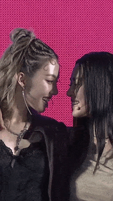 two women standing next to each other with one wearing a shirt that says ' balenciaga ' on it