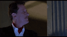 a man in a tuxedo stands next to another man and says jesus