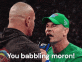 a man wearing a green shirt that says you babbling moron