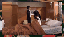 a man and woman in a hospital room with sbs written on the bottom
