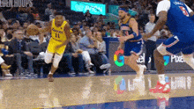 a basketball player with the number 11 on his jersey is dribbling the ball