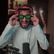 a man wearing a headset and sunglasses with the word saudi on them