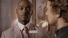 a man in a suit and tie is talking to another man in a suit .