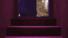 a group of women are sitting in an attic with a wicker chair