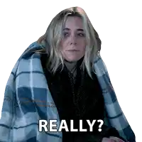 a woman is wrapped in a plaid blanket and says really ?