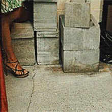 a woman is standing in front of a pile of boxes .