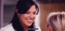 a woman is smiling and saying `` i love you too '' to another woman .