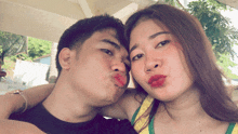 a man and a woman are posing for a picture and the woman is wearing red lipstick