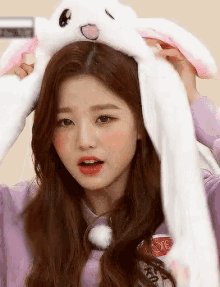 a girl wearing bunny ears and a purple shirt with the letter s on it