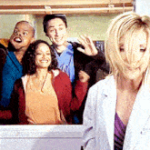 a woman in a white lab coat is standing in front of a group of people