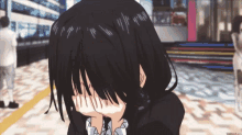 a girl with black hair is covering her face with her hands in a scene from an anime