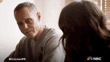 a man talking to a woman with #chicagopd written on the bottom right