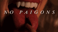 a woman with vampire teeth sticking her tongue out with the words no paigns written above her