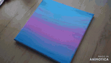 a person is painting on a canvas with the words made in animotica