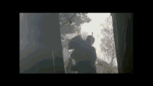 a man is holding a woman in his arms in a dark room in a video .
