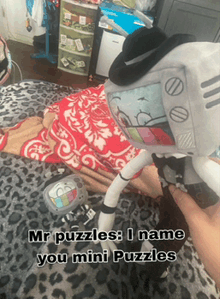 a person is holding a stuffed toy that says mr puzzles
